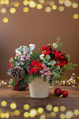 Christmas greeting card, red poinsettia, pine cones and fir branches, vertical image
