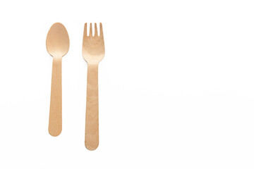 wooden spoon and folks isolated on the white background ready to cook and taste with the ingredients of your choice. Place for text. Copy space