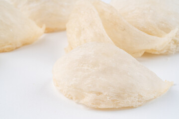Top Grade edible bird nest shoot on white background with negative space. Raw edible bird's nest materials for tradition chinese medicine. Swallow nest the traditional chinese delicacy.
