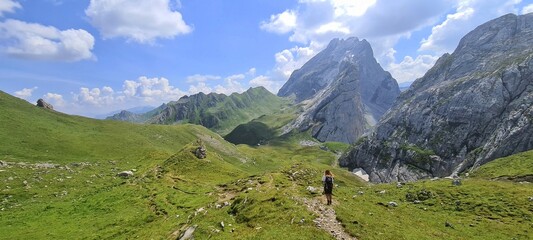 Fototapeta na wymiar A girl hiking in the Ratikon Alps through Austria and Switzerland.