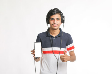young man using headphone and showing smartphone on white background.