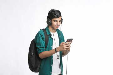 young man using smartphone and headphone accessory.