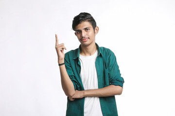 Young indian man giving expression with hand over white background.