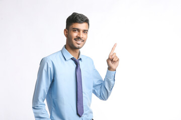 Successful Young indian business man posing over white background