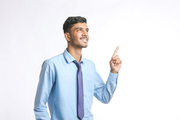 Successful Young indian business man posing over white background