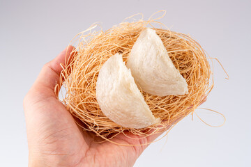 Top Grade edible bird nest shoot on white background with negative space. Raw edible bird's nest materials for tradition chinese medicine. Swallow nest the traditional chinese delicacy.