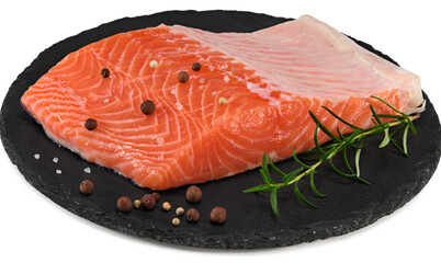 Red fish. Raw salmon fillet with rosemary and peppercorns on black round stone plate isolate on white background. Clipping path and full depth of field