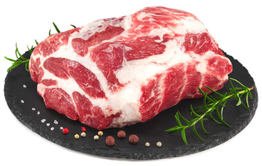 raw pork meat with rosemar and peppercorn on black round stone plate isolated on white background. Clipping path and full depth of field