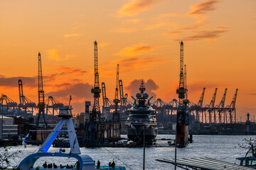 Super-yacht in a dock on the river Elbe at sunset in the port of Hamburg - obrazy, fototapety, plakaty