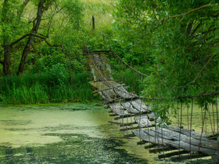 a collapsed wooden pedestrian bridge over the river