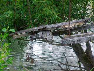 a collapsed wooden pedestrian bridge over the river