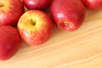Ripe red many apples on wooden background with copy space.