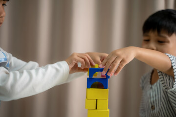 Asia childrens playing with wood blocks in room at home,Homeschooling,Learning community.