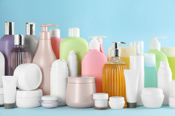 Many different cosmetic products on light blue background