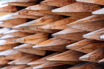 Wooden stakes pattern. Treated tree trunks