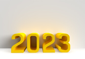Big yellow modern number new year 2023 on a grey wall.