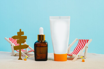 Summer sunscreen cream banner ads. Beach holiday cosmetics. Sun cream and sun essence. Unisex cosmetics. Concept photo of relaxing on the beach. Deck chairs on the sand on a blue background. Mockup 
