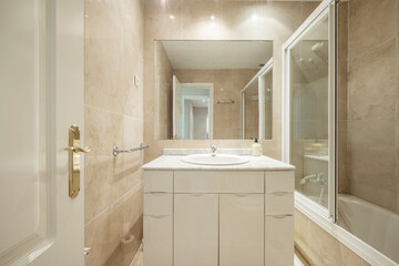 Service with white lacquered furniture, granite countertop and walls covered with cream-colored marble