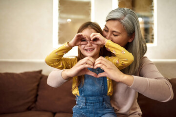 Lovely girl and grandmother having fun together