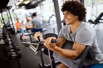 Portrait of fit man working out in gym. Sport people healthy lifestyle exercise concept