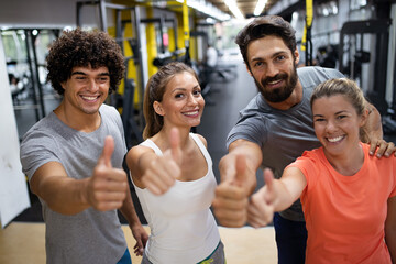 Fototapeta na wymiar Portrait of happy fit group of people working out in gym together