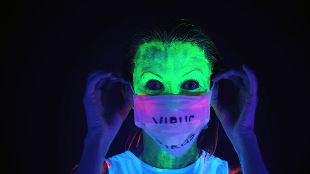 Photo of undressing mask woman with scary painted face
