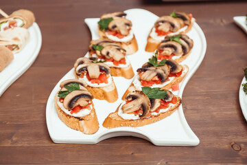bruschetta with fried mushrooms, tomatoes and herbs and cheese sauce