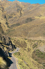 autumn scenery of a road on top of a mountain with a small car in Merlo, San Luis Argentina, travel...