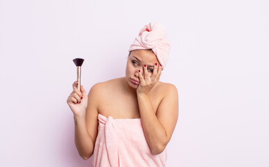 hispanic pretty woman feeling bored, frustrated and sleepy after a tiresome. make up brush concept