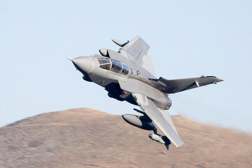 jet fighter, military aircraft flying low level in the United Kingdom. Military aeroplane on a combat training mission
