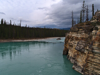 Beautiful view of Athabasca River in Jasper National Park, Alberta, Canada in the Rocky Mountains with colorful eroded rocks with layer pattern-