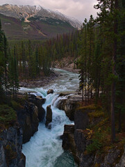 Stunning view of popular waterfall Sunwapta Falls near Icelfields Parkway in Jasper National Park, Alberta, Canada in the Rocky Mountains in autumn.