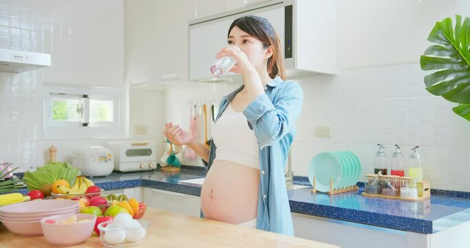 Asian pregnant woman take vitamin