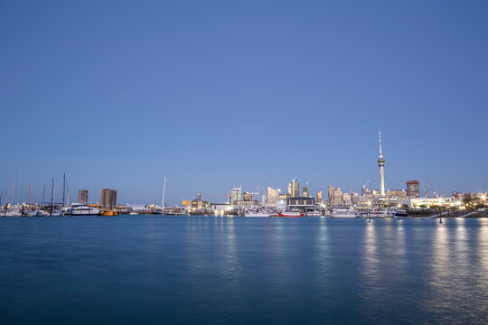 View of Auckland harbour from the bay with sky tower and city downtown in background, Auckland, New Zealand.