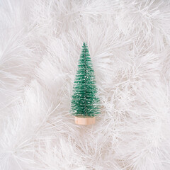 Christmas tree in a white garland. Minimal  New Year concept.  Winter aesthetic composition.