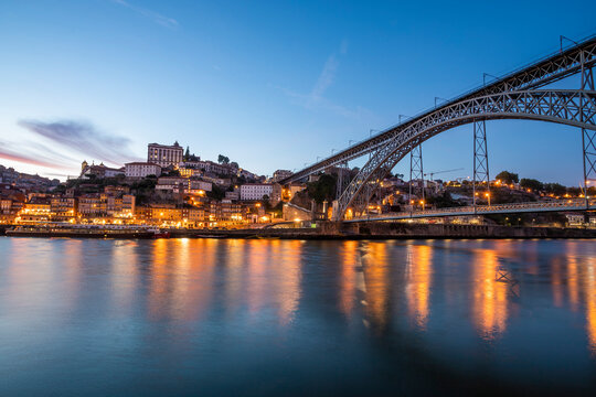 View of Porto cityscape along the Douro river with Luis I bridge in foreground, Porto, Portugal.