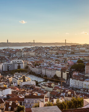 View of Lisbon downtown from Graca hilltop, view of April 25th bridge crossing Tagus river, Lisbon, Portugal.