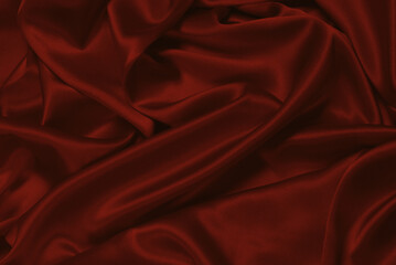 Rich and luxury red silk fabric texture background.