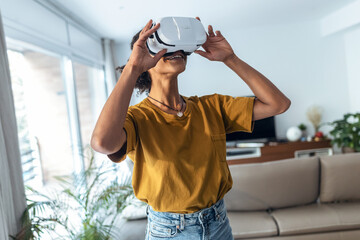 Modern mature entrepreneur woman using virtual reality headset and enjoying the moment in the office.