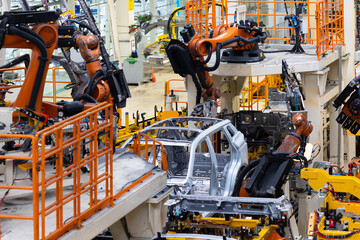 Photo of car bodies are on assembly line. Factory for production of cars. Modern automotive industry. Electric car factory, conveyor
