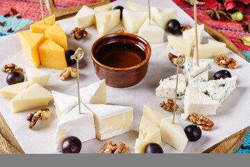 cheese plate with walnuts and grapes