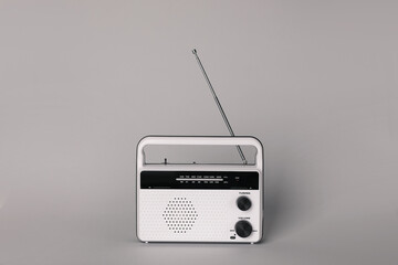 Portable retro radio receiver on grey background