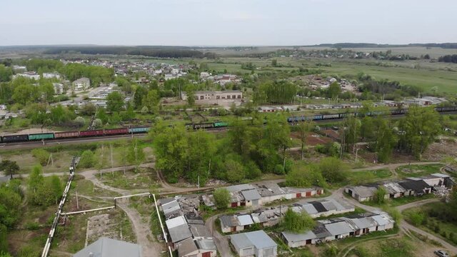 Aerial view of a freight train passing by the village (Strizhi, Kirov region, Russia)