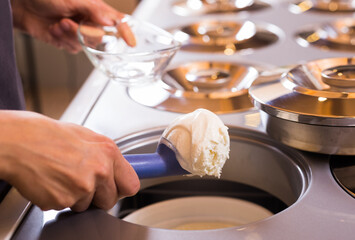 Ball of vanilla ice cream in ice cream razor in cafe