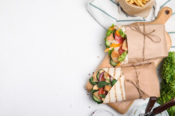 Delicious shawarmas with chicken and fresh vegetables on white table, flat lay. Space for text