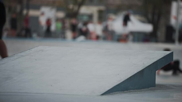 Skaters workout. Skateboarding.  Jumping springboard. Boardslide. Skaters are practicing in the skate park. Urban leisure.