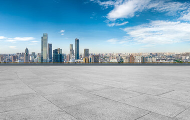 Empty brick floor with city skyline background