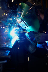 Industrial welder worker at factory welding steel