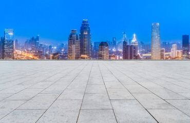 Empty brick floor with city skyline background