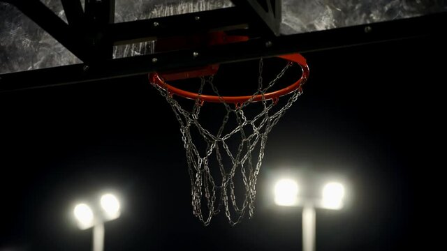 Battle for the ball at the opponent's hoop. Tense moment. Attempts to throw the ball. Basketball hoop. Sports arena for playing basketball. Opening an account.